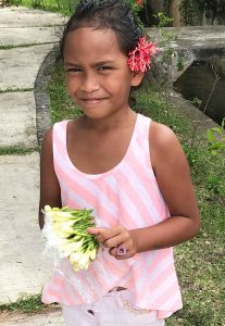 This little girl was handlng out tiare flowers for visitors to put behind their ears — left if you're taken, right if you're available. 