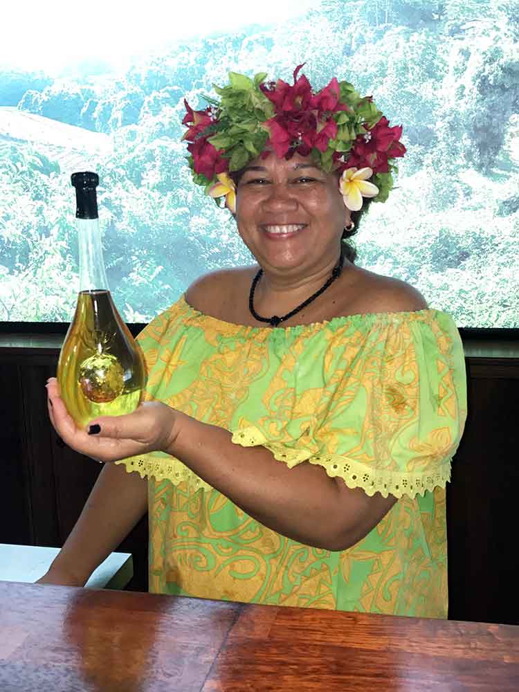 Tasting hostess at Manutea displays the liqueur made from pineapples.