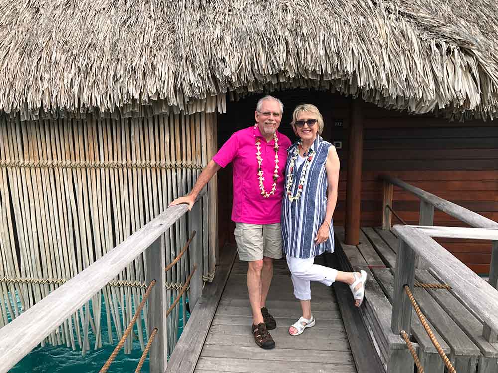 Us in front of our overwater bungalow at Four Seasons Bora Bora.