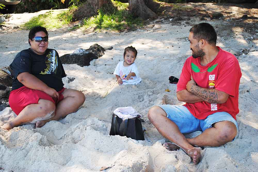 A Tahitian family enjoying their local beach.