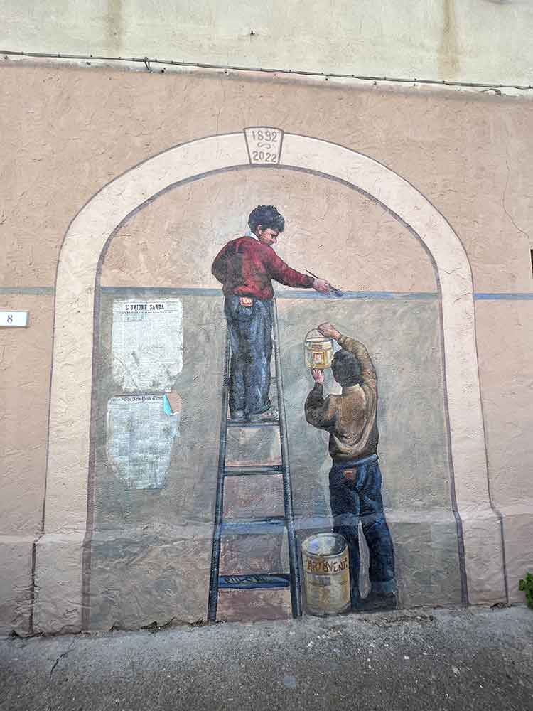 Mural showing man on ladder, San Sperate