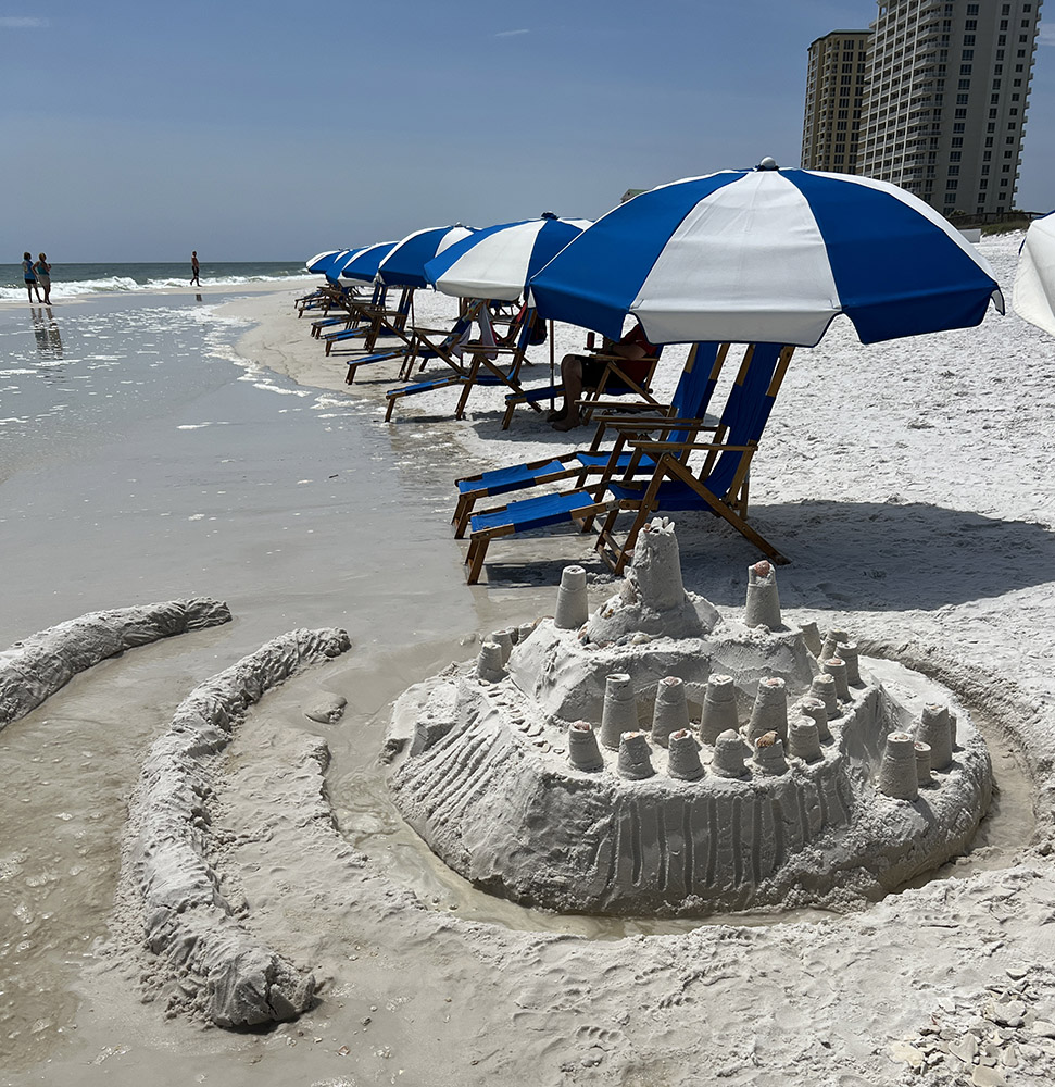 Navarre Beach with sandcastle and umbrellas