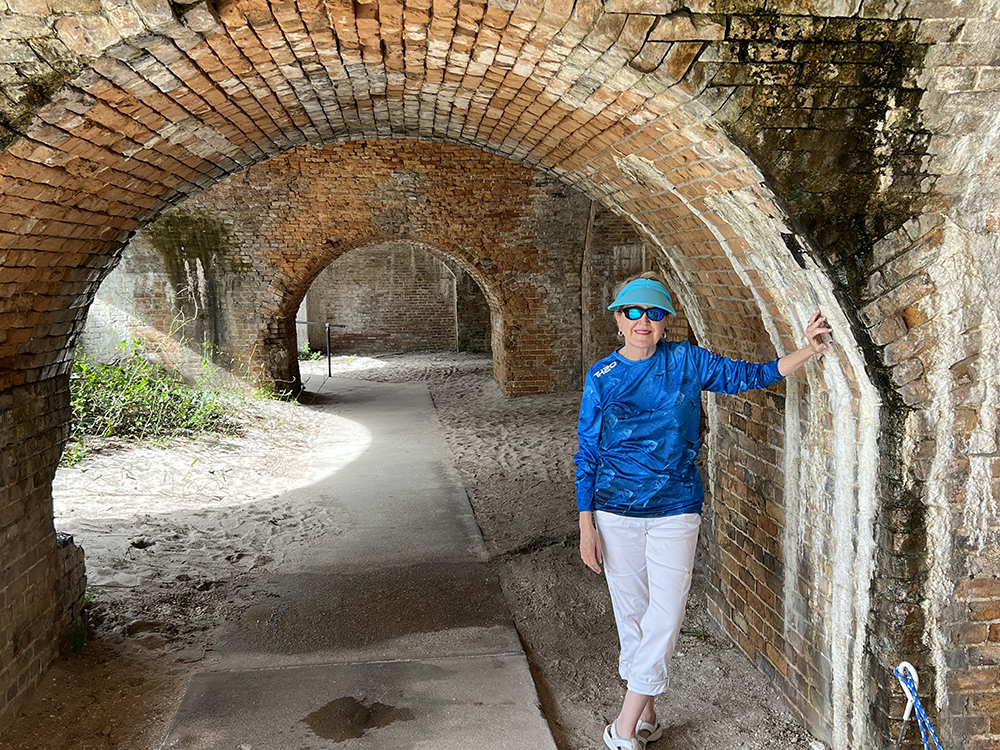 Me standing by one of the arched brick corridors of Fort Pickens ©Debbra Dunning Brouillette