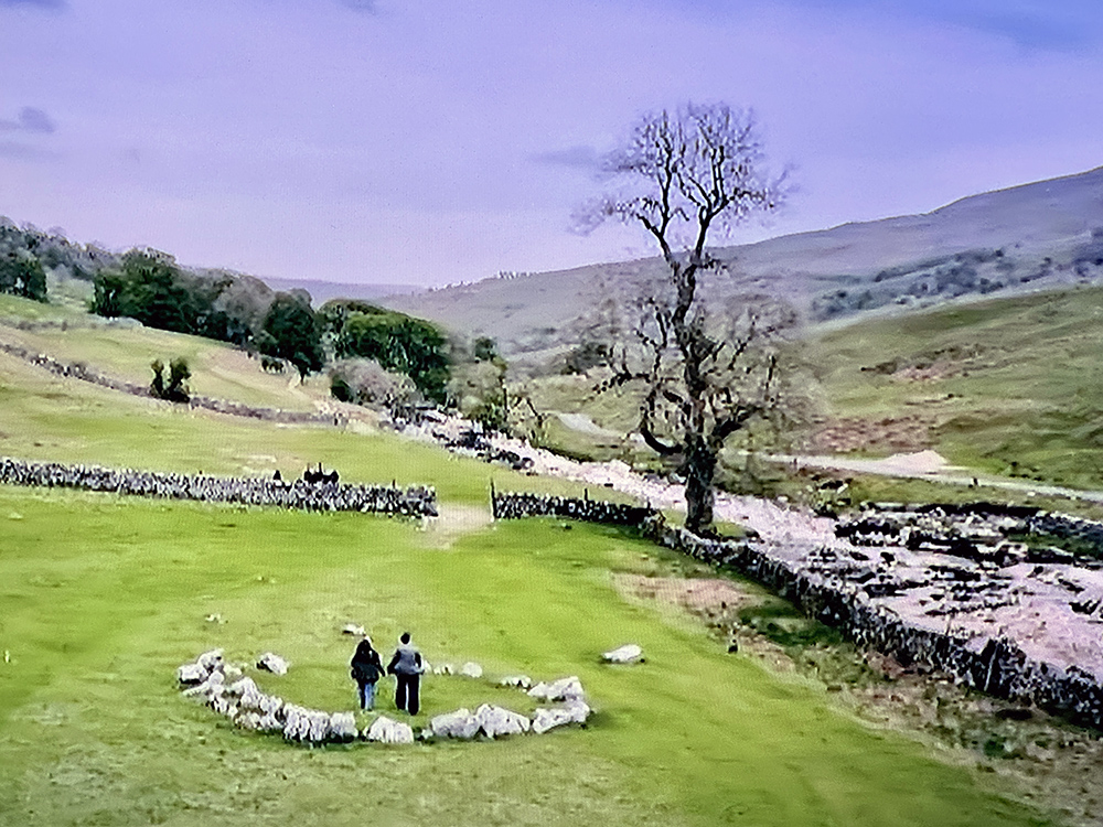Screenshot from PBS Special Season of the Dales showing two walking inside the Yockentwaite Stone Circle